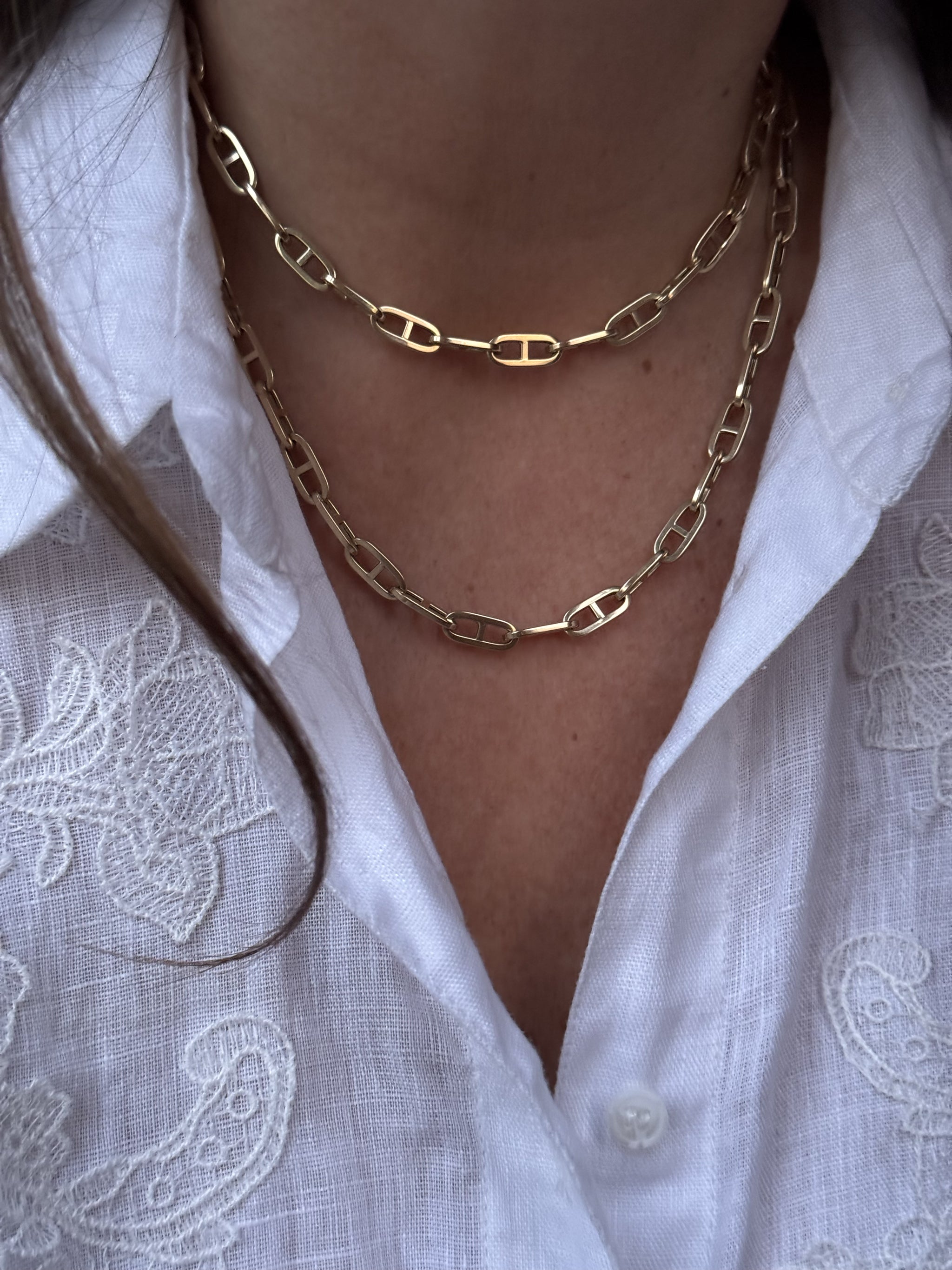 Boheme Grande Marine Chain by Delphine Leymarie in 14k yellow gold styled as a double-wrap necklace over a white embroidered linen shirt