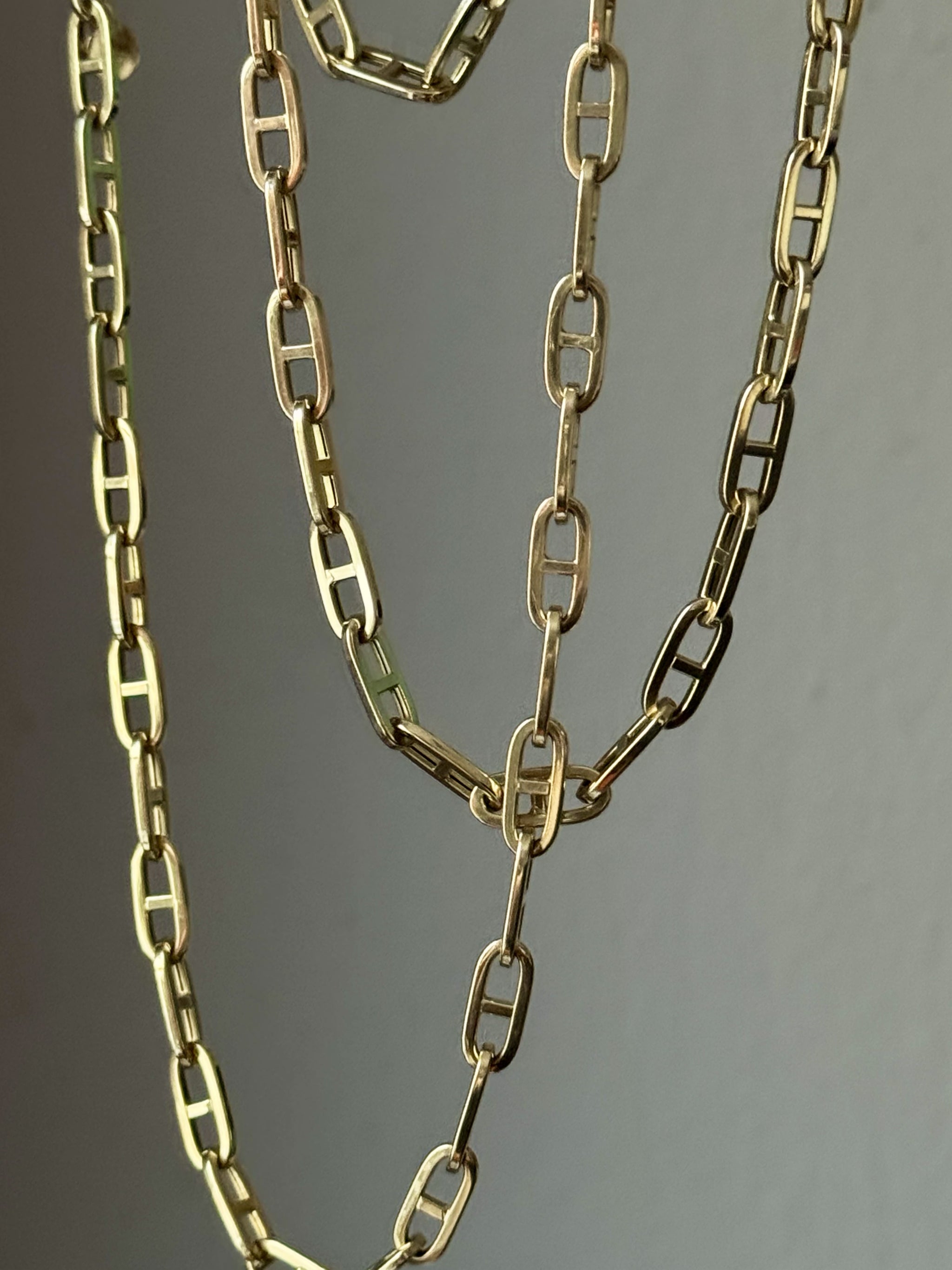 Boheme Grande Marine Chain in 14k yellow gold by Delphine Leymarie, statement anchor-inspired chain on a gray background