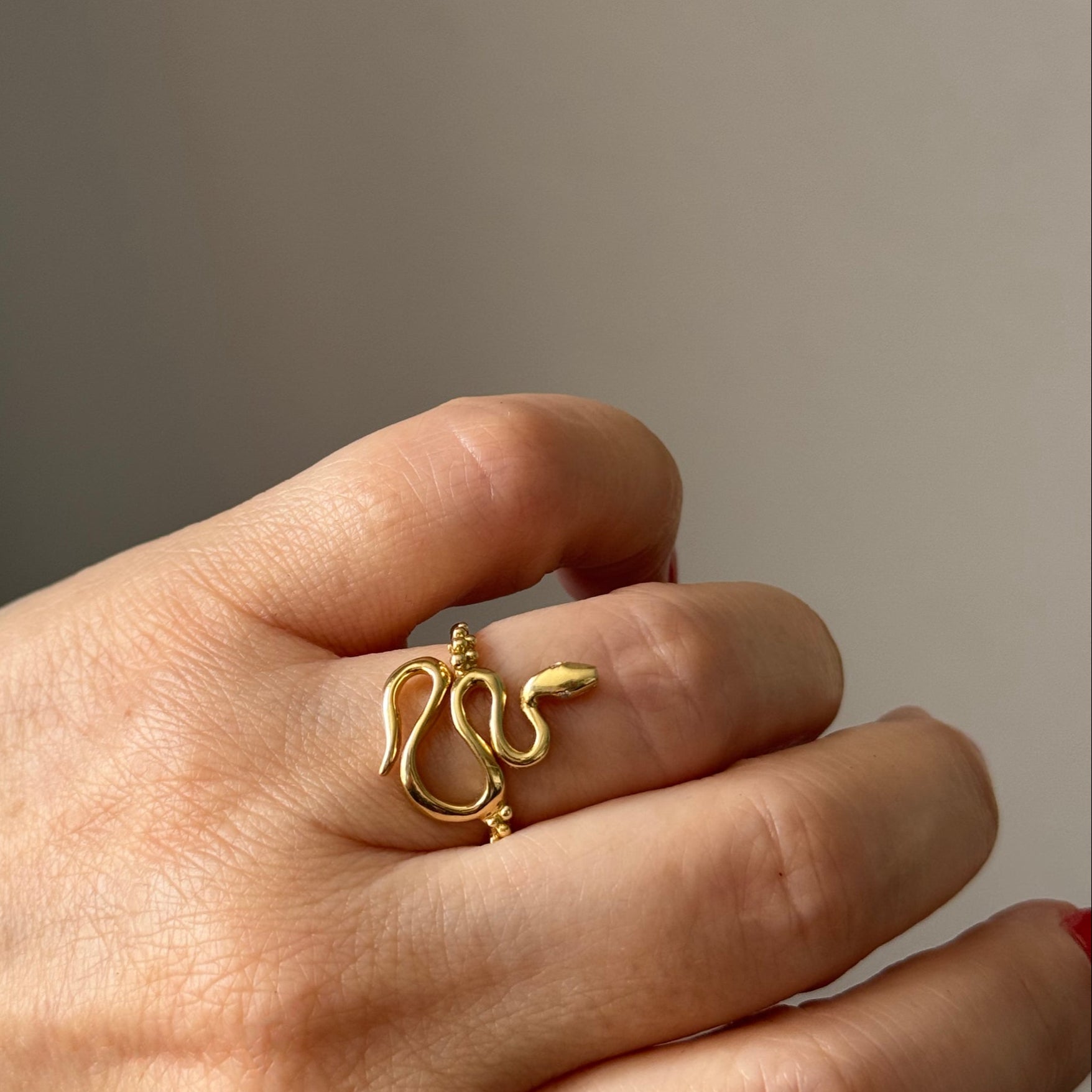Boheme 18k recycled gold diamond Snake Ring on a Model's Hand held sideway