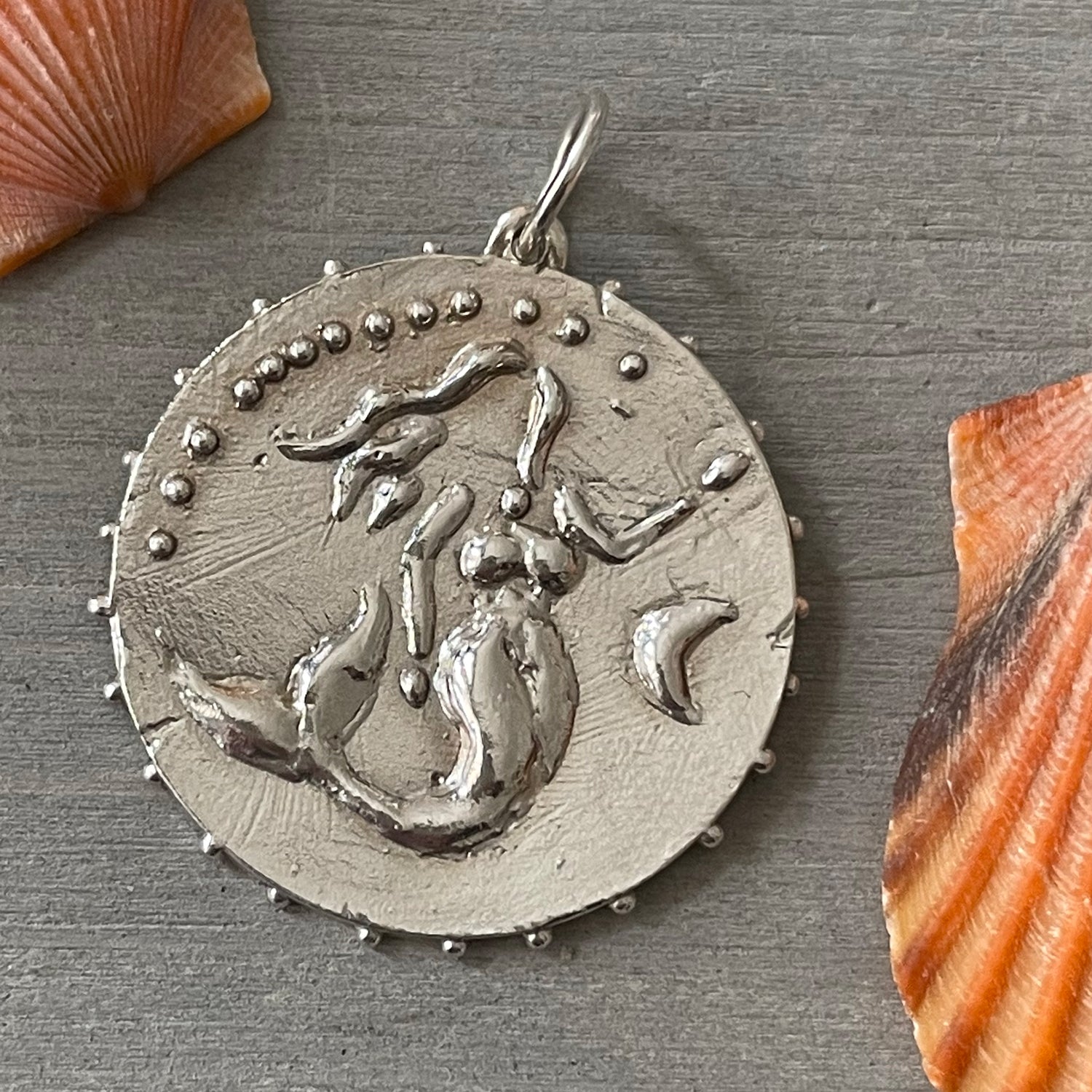 Delphine Leymarie Boheme Grande Sirene Medallion mermaid Silver over Grey Wood surrounded by orange shells