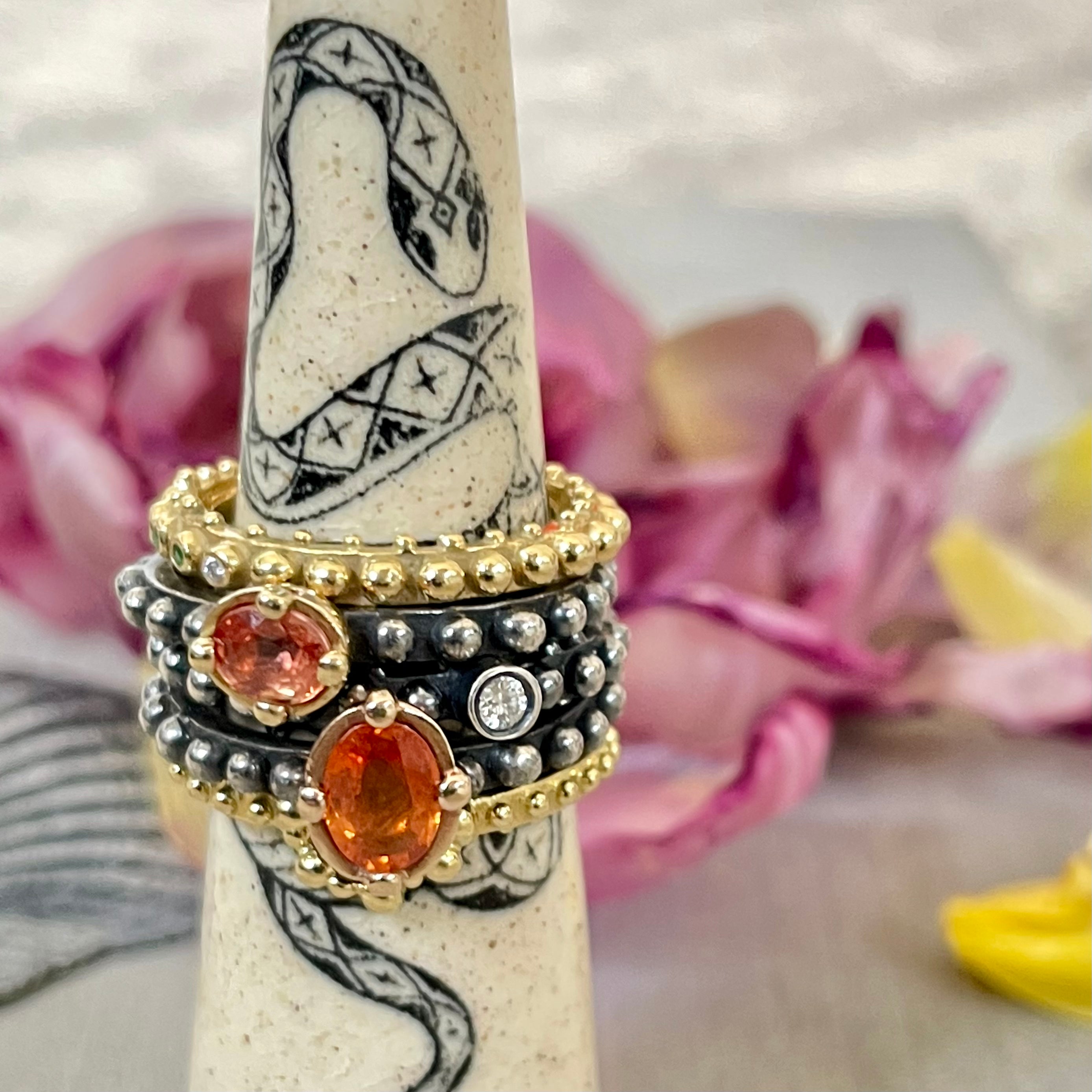 Boheme orange sapphire and diamond recycled gold and oxidized silverring stack on snake ring holder