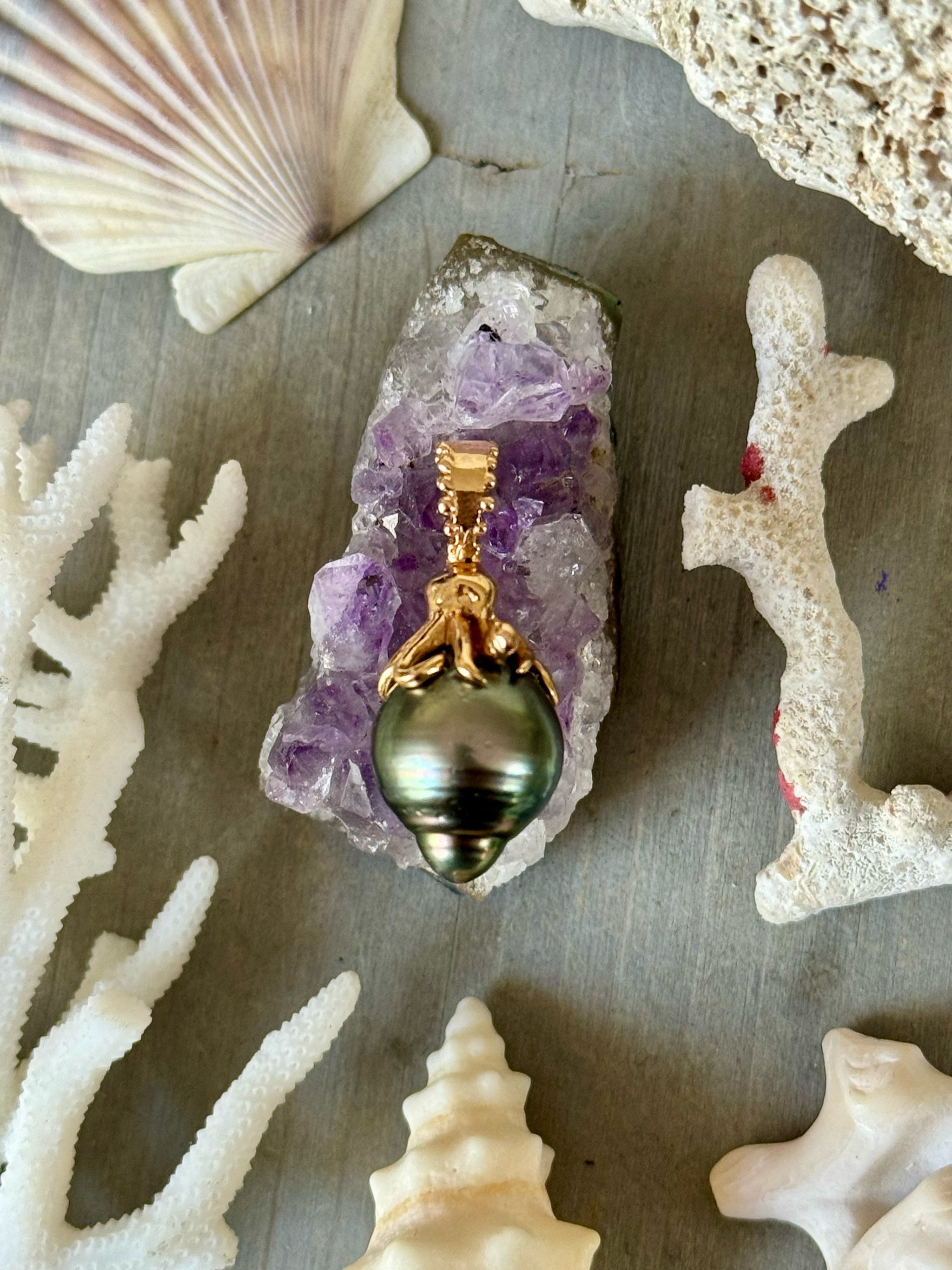 Delphine Leymarie Boheme octopus and Tahitian Pearl Talisman in 18k rose goldan amethyst crystal with shells and coral in the background
