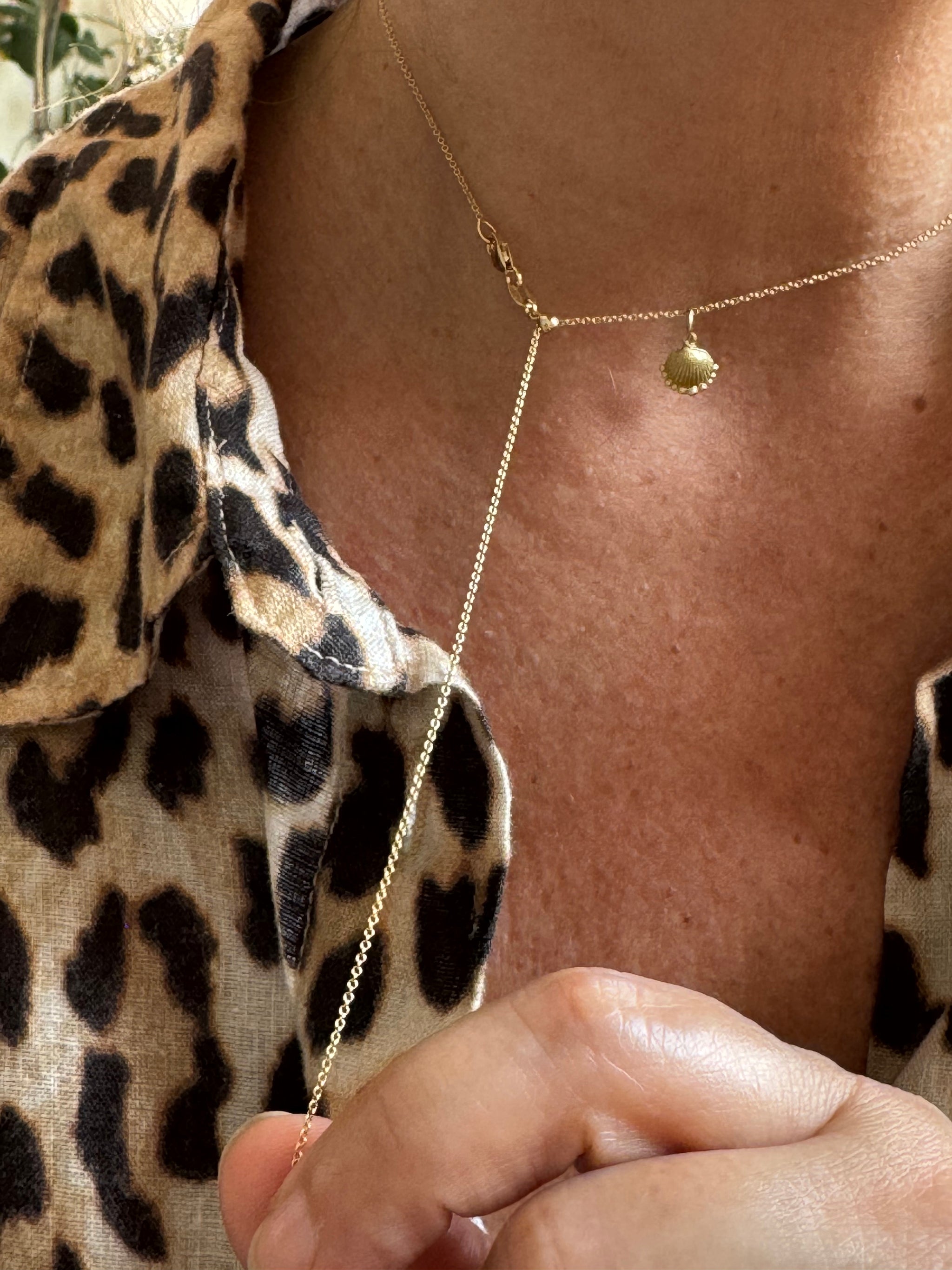 Demonstration of Delphine Leymarie 18k recycled gold sliding bead cable chain, adjustable length in motion.