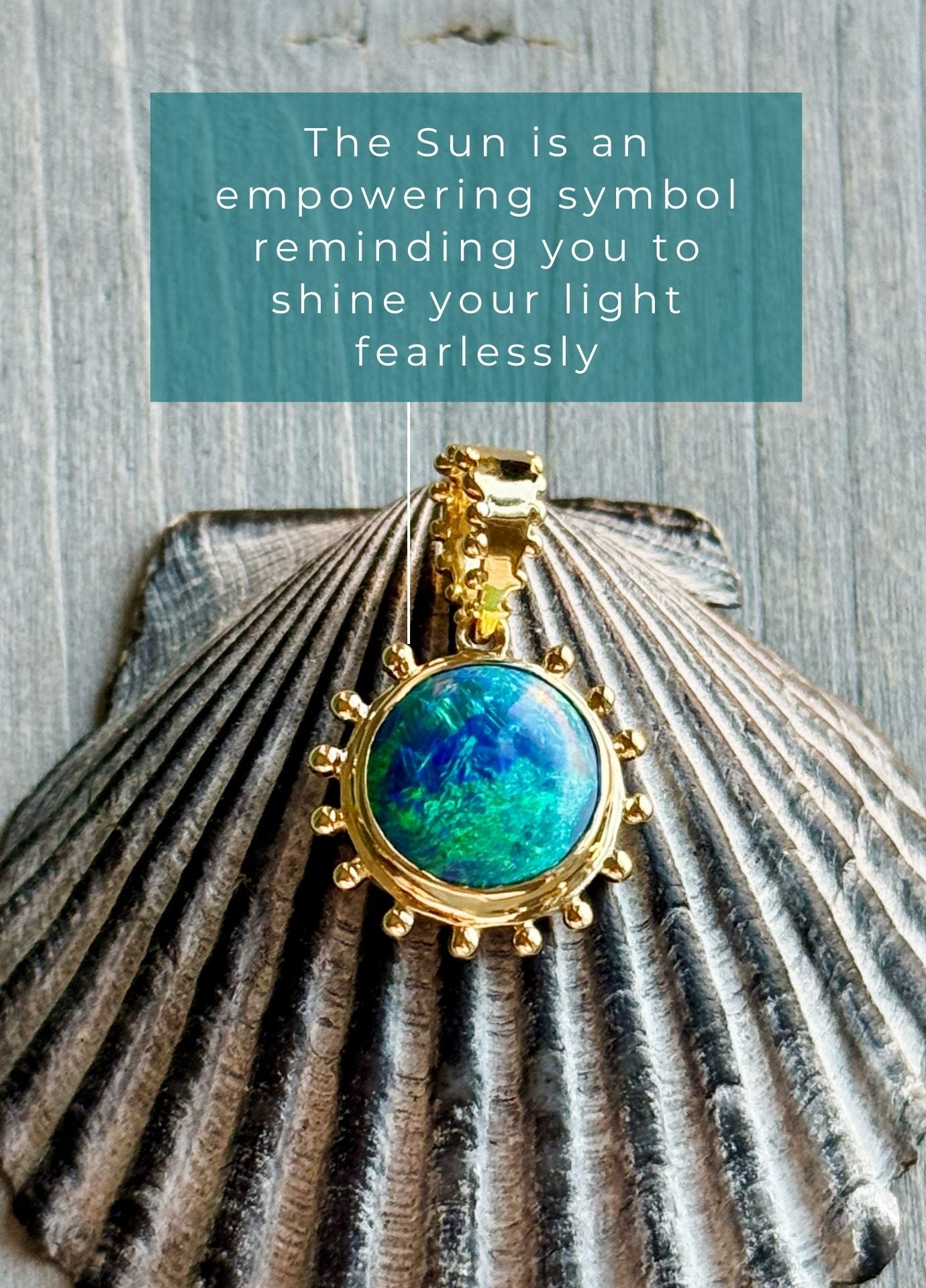 18k recycled Gold Soleil charm talisman pendant with blue opal on a shell against a wooden background with sun symbolism text.